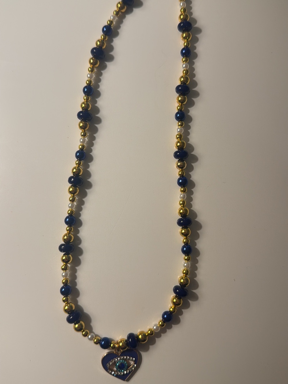 Artisan Blue and Gold Beaded Necklace with Heart Evil Eye Charm